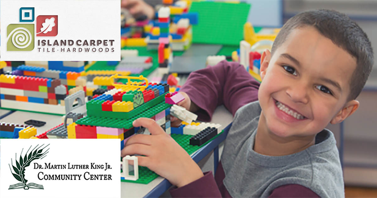 Child playing with legos with Island Carpet and Martin Luther King Jr. Community Center logos in the corner